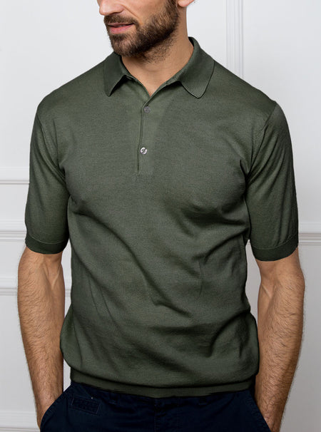 Man wearing palm green short sleeved polo neck knit in a luxury and premium 100% merino wool.